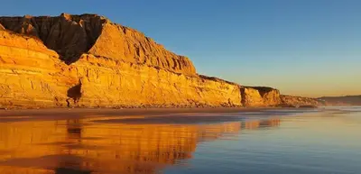 a view of a beach with a large cliff at Sand Pebbles Resort - Amazing 2 Bedroom Condo Right by the Beaches & Attractions in Solana Beach