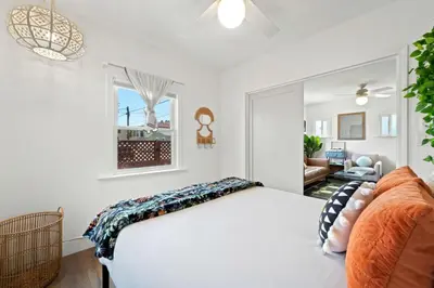 a bedroom with a white bed and a window at North Park Boho Bungalow by Rather Be Properties in San Diego