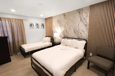 a hotel room with two beds and a chair at 8356 Adam back unit 2bed 2bath by sdstay in Lemon Grove