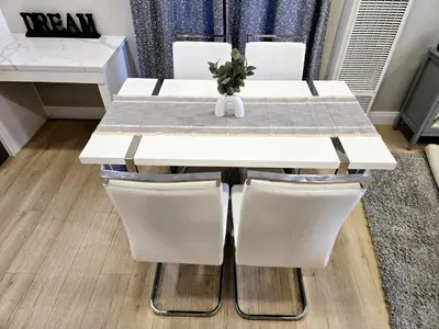 a white dining table with two white chairs at 8356 Adam back unit 2bed 2bath by sdstay in Lemon Grove
