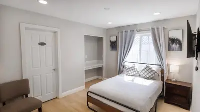 a bedroom with a bed and a desk and a window at 8356 Adam back unit 2bed 2bath by sdstay in Lemon Grove