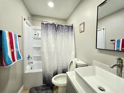 a bathroom with a white toilet and a sink at 8356 Adam back unit 2bed 2bath by sdstay in Lemon Grove