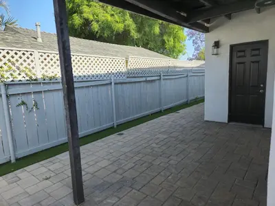 a driveway with a fence and a door at 8356 Adam back unit 2bed 2bath by sdstay in Lemon Grove
