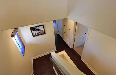 an overhead view of a staircase in a house at Lower West Newport in Newport Beach