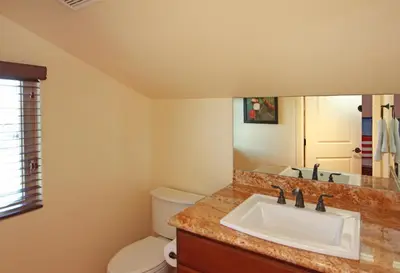 a bathroom with a sink and a toilet at Lower West Newport in Newport Beach