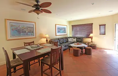 a living room with a table and a couch at Lower West Newport in Newport Beach