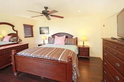 a bedroom with a bed and a ceiling fan at Lower West Newport in Newport Beach