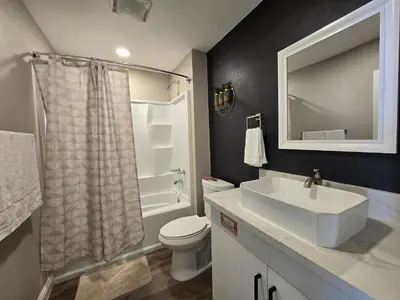 a bathroom with a sink and a toilet and a mirror at Gillespie 2bed 1 bath 1063 by SD Stay in Spring Valley