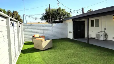 a patio with a chair on the grass at Gillespie 2bed 1 bath 1063 by SD Stay in Spring Valley