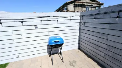 a blue toaster sitting on the side of a fence at Gillespie 2bed 1 bath 1063 by SD Stay in Spring Valley