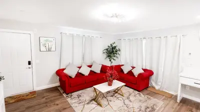 a living room with a red couch and a table at Gillespie 2bed 1 bath 1063 by SD Stay in Spring Valley