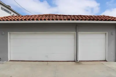 two white garage doors on a house at 1101 W Bay Ave in Newport Beach