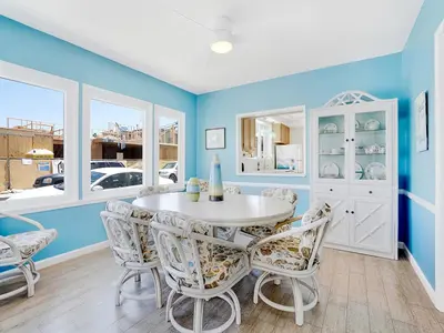 a dining room with blue walls and a table and chairs at 1101 W Bay Ave in Newport Beach