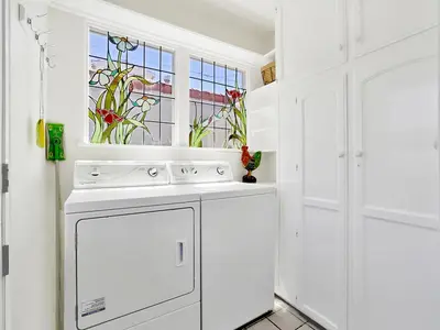 a white kitchen with a dishwasher and a window at 1101 W Bay Ave in Newport Beach