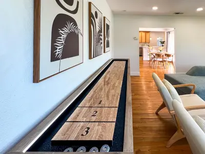 a bowling alley floor in a living room at Modern Boho Oasis - Fast Wifi & Shuffleboard! in San Diego