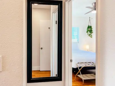 a mirror in a room with a bedroom at Modern Boho Oasis - Fast Wifi & Shuffleboard! in San Diego