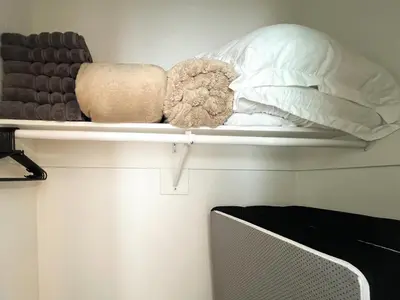 a shelf with pillows and other items on it at Modern Boho Oasis - Fast Wifi & Shuffleboard! in San Diego