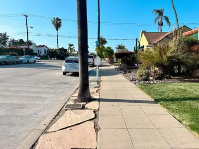 a white car parked on the side of a street at Modern Boho Oasis - Fast Wifi & Shuffleboard! in San Diego