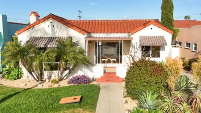 a white house with a pathway leading to it at Modern Boho Oasis - Fast Wifi & Shuffleboard! in San Diego