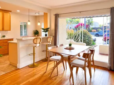 a kitchen and dining room with a table and chairs at Modern Boho Oasis - Fast Wifi & Shuffleboard! in San Diego