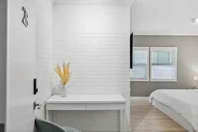 a white bedroom with a bed and a table at 1628 West Oceanfront Oasis - All Units in Newport Beach