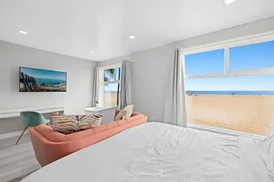 a bedroom with a bed and a couch and a window at 1628 West Oceanfront Oasis - 5,8,9 in Newport Beach