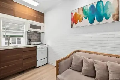 a living room with a couch and a kitchen at 1628 West Oceanfront Oasis - 5,8,9 in Newport Beach