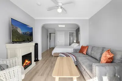 a living room with a couch and a fireplace at 1628 West Oceanfront Oasis 2 in Newport Beach