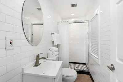 a white bathroom with a sink and a mirror at 1628 West Oceanfront Oasis 2 in Newport Beach