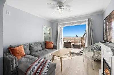 a living room with a couch and a table at 1628 West Oceanfront Oasis 1,2,3 in Newport Beach