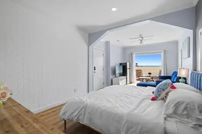 a bedroom with a bed and a view of the beach at 1628 West Oceanfront Oasis 1,2,3 in Newport Beach
