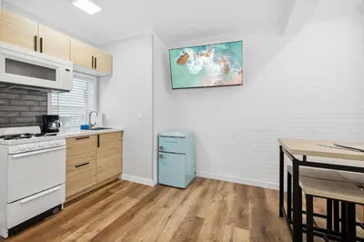 a kitchen with a blue refrigerator next to a table at 1628 West Oceanfront Oasis 2,3 in Newport Beach