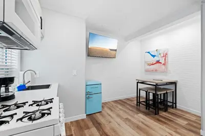 a kitchen with a stove and a small table at 1628 West Oceanfront Oasis 2,3 in Newport Beach