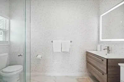 a bathroom with a toilet and a glass shower at 1628 West Oceanfront Oasis 4,5,6,7,8,9 in Newport Beach