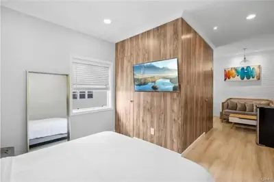 a bedroom with a white bed and a couch at 1628 West Oceanfront Oasis 4,5,6,7,8,9 in Newport Beach