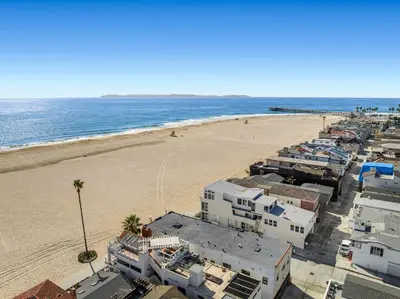 an aerial view of a beach with buildings and the ocean at 1628 West Oceanfront Oasis 3 in Newport Beach