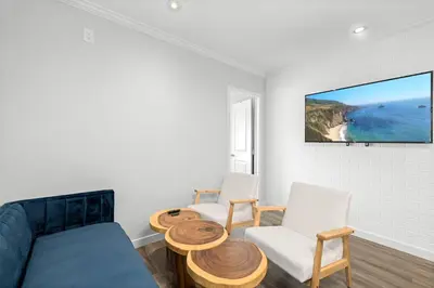 a living room with a couch and two chairs at 1628 West Oceanfront Oasis 7 in Newport Beach