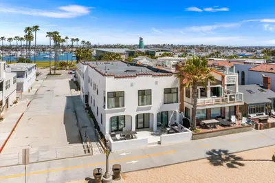 an aerial view of a white building with palm trees at 1628 West Oceanfront Oasis 7 in Newport Beach