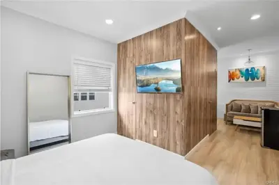 a bedroom with a white bed and a couch at 1628 West Oceanfront Oasis 9 in Newport Beach