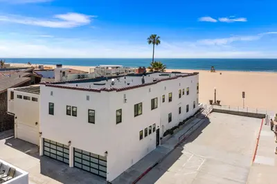 an aerial view of a white building next to the beach at 1628 West Oceanfront Oasis 8 in Newport Beach