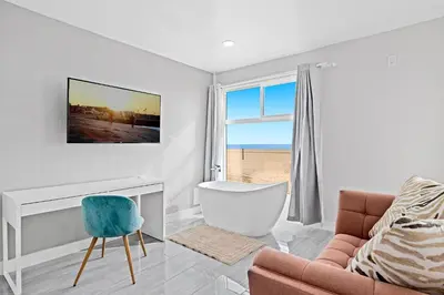 a living room with a couch and a chair at 1628 West Oceanfront Oasis 8 in Newport Beach
