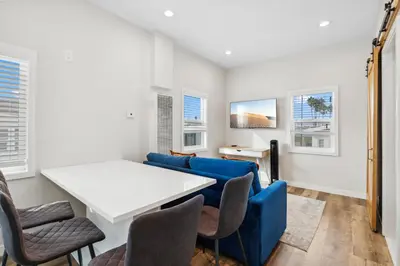 a living room with a couch and a table and chairs at 1628 West Oceanfront Oasis 5 in Newport Beach