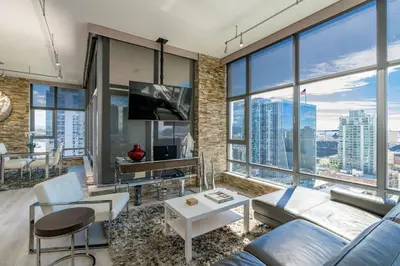 a living room with a couch and a table at Cityscape Elegance with Water Views in San Diego