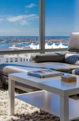 a living room with a couch and a table with books at Cityscape Elegance with Water Views in San Diego