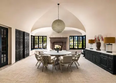 a dining room with a table and chairs and a fireplace at Exclusive Spanish Mediterranean Mansion in Rancho Santa Fe