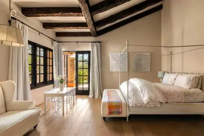 a bedroom with a bed and a couch and a table at Exclusive Spanish Mediterranean Mansion in Rancho Santa Fe