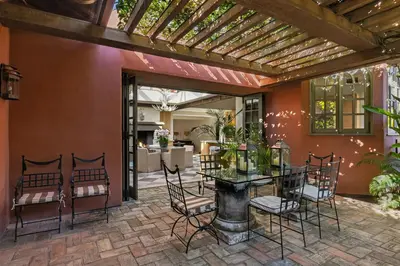 an outdoor patio with a table and chairs at Exclusive Spanish Mediterranean Mansion in Rancho Santa Fe