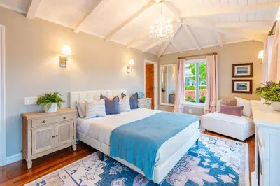 a bedroom with a large bed and a chandelier at Dolphin's Paradise in San Diego