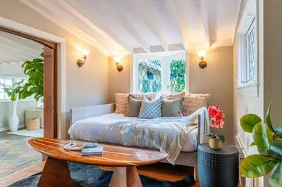 a living room with a bed and a table at Dolphin's Paradise in San Diego