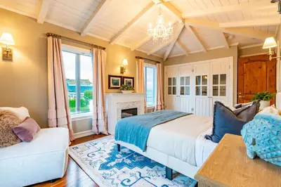 a bedroom with a bed and a fireplace at Dolphin's Paradise in San Diego